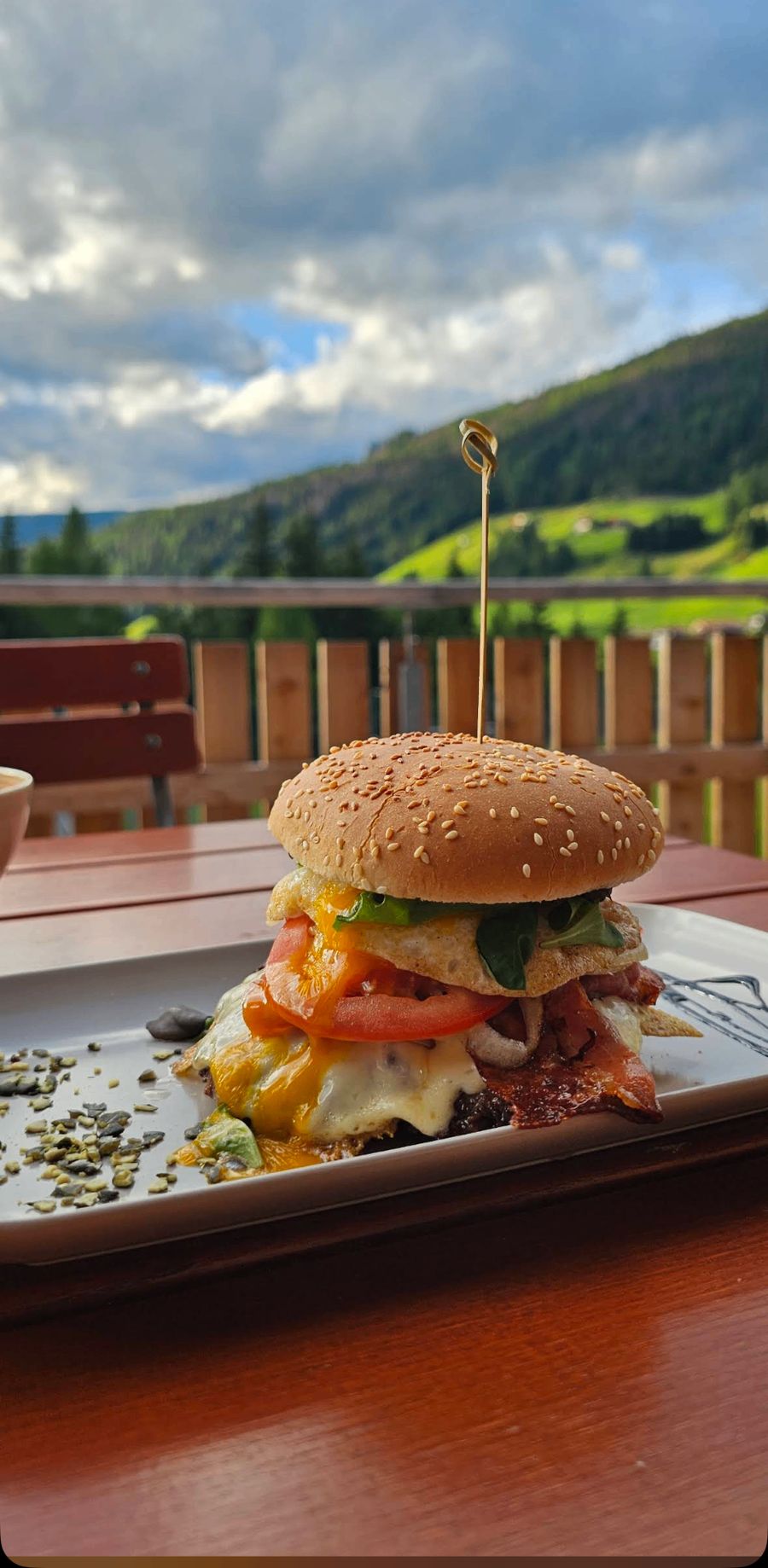 Michis Burger mit Spiegelei, Speck und Käse auf der Terrasse mit Bergblick